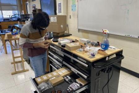 Mili organizing the tool chest.